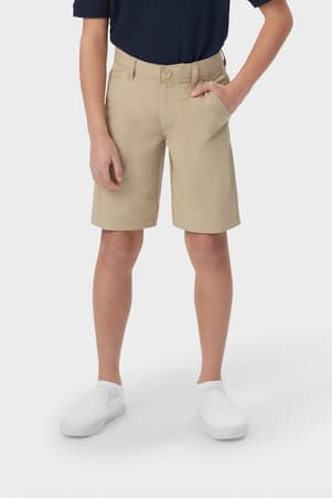 Boy in khaki French Toast flat front performance shorts, showing above-knee length with moisture-wicking fabric, front view. of  Boys' Flat Front Stretch Performance Short