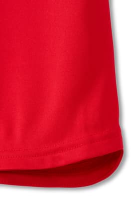 Closeup detailed view of hem. of  New! Short Sleeve Performance Polo (Feminine Fit)