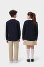 Back view of boy and girl wearing navy French Toast v-neck cardigan sweaters, highlighting ribbed hem. of  V-Neck Sweater Cardigan opens large image - 4 of 4
