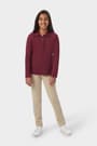 Girl wearing a French Toast burgundy long sleeve fitted interlock polo, front view showing feminine fit and picot trim collar. of  Long Sleeve Fitted Interlock Polo with Picot Collar (Feminine Fit) opens large image - 3 of 4