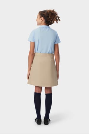 Girl in khaki French Toast pleated two-tab skort, back view showing above the knee length and hidden built-in knit short.