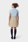 Girl in khaki French Toast pleated two-tab skort, back view showing above the knee length and hidden built-in knit short.