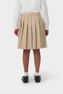 Back view of girl wearing khaki French Toast at the knee pleated skirt, showcasing easy care twill pleated fabric.