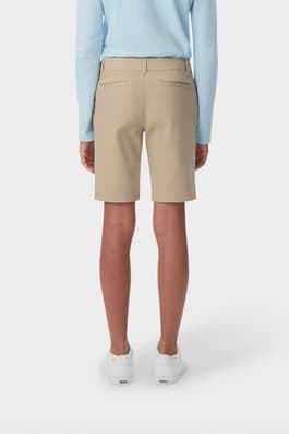 Girl wearing khaki French Toast twill Bermuda short, back shot showcasing welted back pockets and waistband with belt loops. of  Girls' Stretch Twill Bermuda Short