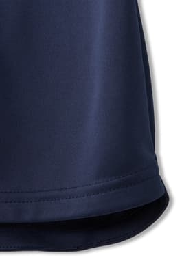 Closeup view of hem of  New! Short Sleeve Performance Polo (Feminine Fit)