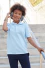 Child in short sleeve polo with headphones. of  Short Sleeve Pique Polo opens large image - 3 of 4