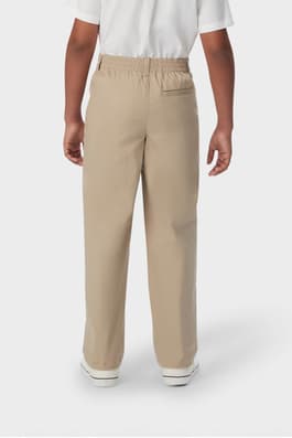 Boy wearing khaki French Toast boys&#39; pull-on relaxed fit stretch twill pant, back view showing elastic waistband. of  Boys' Pull-On Relaxed Fit Stretch Twill Pant