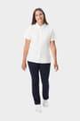 Young woman wearing a white French Toast short sleeve fitted oxford blouse, front view showing buttons and length. of  Short Sleeve Fitted Oxford Shirt (Feminine Fit) opens large image - 5 of 5
