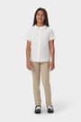 Girl wearing white French Toast girls' short sleeve Peter Pan collar blouse, front view showing collar and button front.