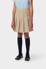 Front view of girl in khaki French Toast pleated two-tab skort, showing front knit pleats and classic tab detail styling.