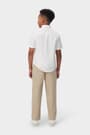 Back view of boy wearing a white French Toast short sleeve oxford shirt, showing hem designed for tucking.