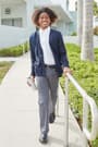 Boy walking in c-neck cardigan sweater and dress pant of  V-Neck Cardigan Sweater - 3 of 3