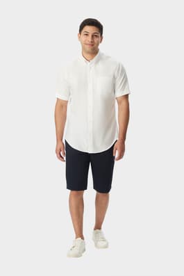 Man wearing a white French Toast short sleeve oxford shirt, front view showcasing classic fit and versatile style.