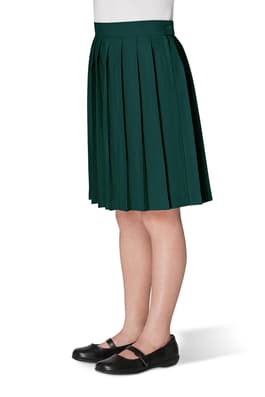 Front view of girl wearing khaki French Toast at the knee pleated skirt, showing knee length and all around knife pleats.