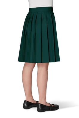 Back view of girl wearing khaki French Toast at the knee pleated skirt, showcasing easy care twill pleated fabric.