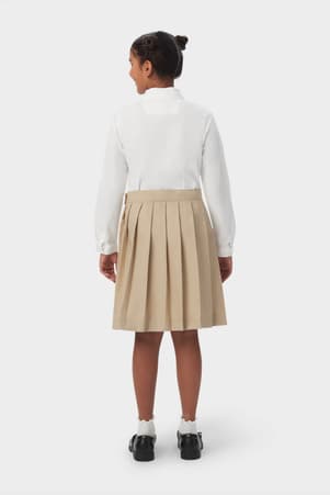 Back view of girl wearing khaki French Toast at the knee pleated skirt, showcasing easy care twill pleated fabric.