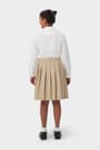 Back view of girl wearing khaki French Toast at the knee pleated skirt, showcasing easy care twill pleated fabric.