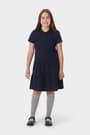 Front view of girl in navy French Toast short sleeve ruffle pique polo dress, showing 3 button placket and knit collar. of  Short Sleeve Ruffle Piqué Polo Dress opens large image - 3 of 4