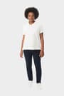 Young woman in French Toast short sleeve fitted stretch pique polo in white, front view showing tailored and feminine fit. of  Short Sleeve Fitted Stretch Pique Polo (Feminine Fit) opens large image - 5 of 5