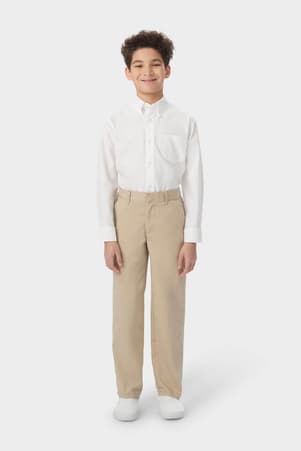 Boy wearing khaki French Toast boys&#39; relaxed fit twill pant, front view showing relaxed fit and waistband with belt loops. of  Boys' Relaxed Fit Twill Pant