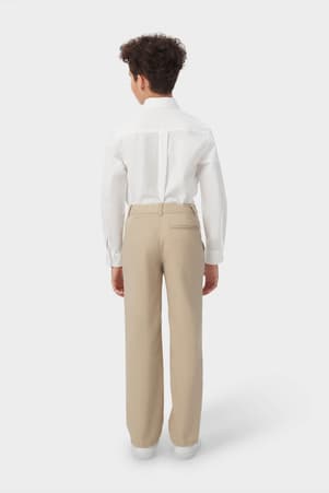 Back view of boy wearing khaki French Toast boys&#39; relaxed fit twill pant, showing back pocket and classic styling. of  Boys' Relaxed Fit Twill Pant