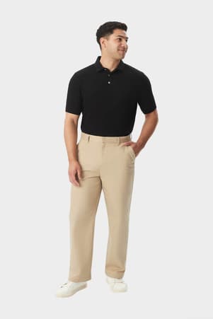 Man wearing khaki French Toast relaxed fit twill pant, front view showing side pocket and classic fit for adults. of  Boys' Relaxed Fit Twill Pant