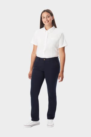Front view of young woman wearing navy French Toast straight fit stretch twill pant, showing button waistband and straight leg. of  Girls' Straight Fit Stretch Twill Pant