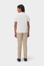 Back view of girl wearing white French Toast short sleeve Peter Pan collar blouse, showing back princess seams.