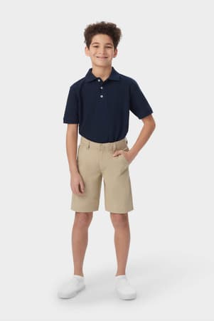 Boy in khaki French Toast flat front performance shorts, showing above-knee length with moisture-wicking fabric, front view. of  Boys' Flat Front Stretch Performance Short