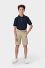 Boy in khaki French Toast flat front performance shorts, showing above-knee length with moisture-wicking fabric, front view. of  Boys' Flat Front Stretch Performance Short opens large image - 3 of 5