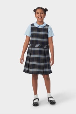 Front view of girl in blue gold plaid French Toast plaid box pleat jumper, showing knee length and front pleats.