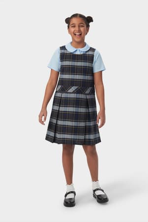 Front view of girl in blue gold plaid French Toast plaid box pleat jumper, showing knee length and front pleats.