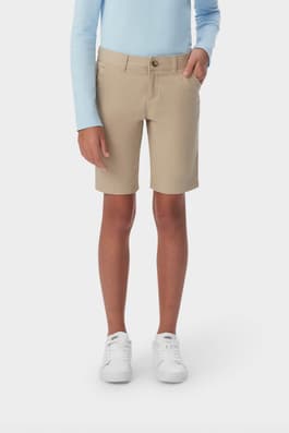 Front view of girl wearing khaki French Toast girls&#39; twill Bermuda short, showing Bermuda length and side pockets. of  Girls' Stretch Twill Bermuda Short