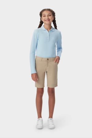 Front view of girl wearing khaki French Toast girls&#39; twill Bermuda short, showing Bermuda length and side pockets. of  Girls' Stretch Twill Bermuda Short
