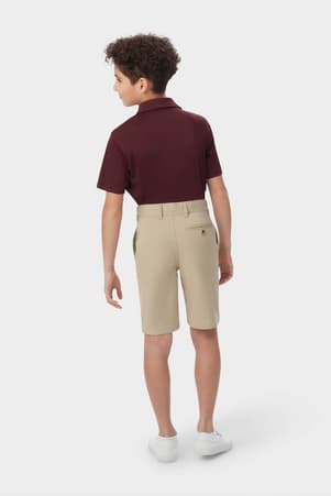 Boy wearing khaki French Toast flat front stretch twill short, back shot showcasing waistband with belt loops and back pocket. of  Boys' Flat Front Stretch Twill Short