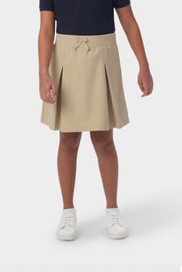 Girl wearing khaki French Toast pull-on kick pleat performance skort, front view showing at the knee length and elastic waistband.