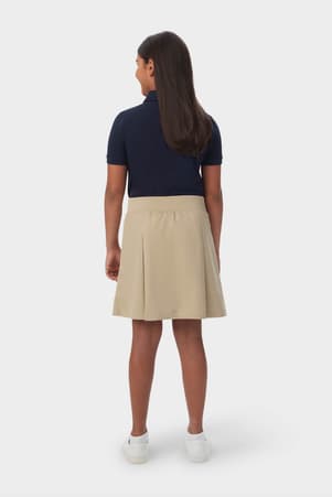 Back view of girl in khaki French Toast pull-on kick pleat performance skort, showing moisture wicking fabric.