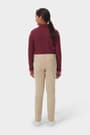 Girl wearing khaki French Toast slim fit stretch Ponte pant, back view showcasing back patch pockets and waistband. of  Girls' Slim Fit Stretch Ponte Pant opens large image - 4 of 4