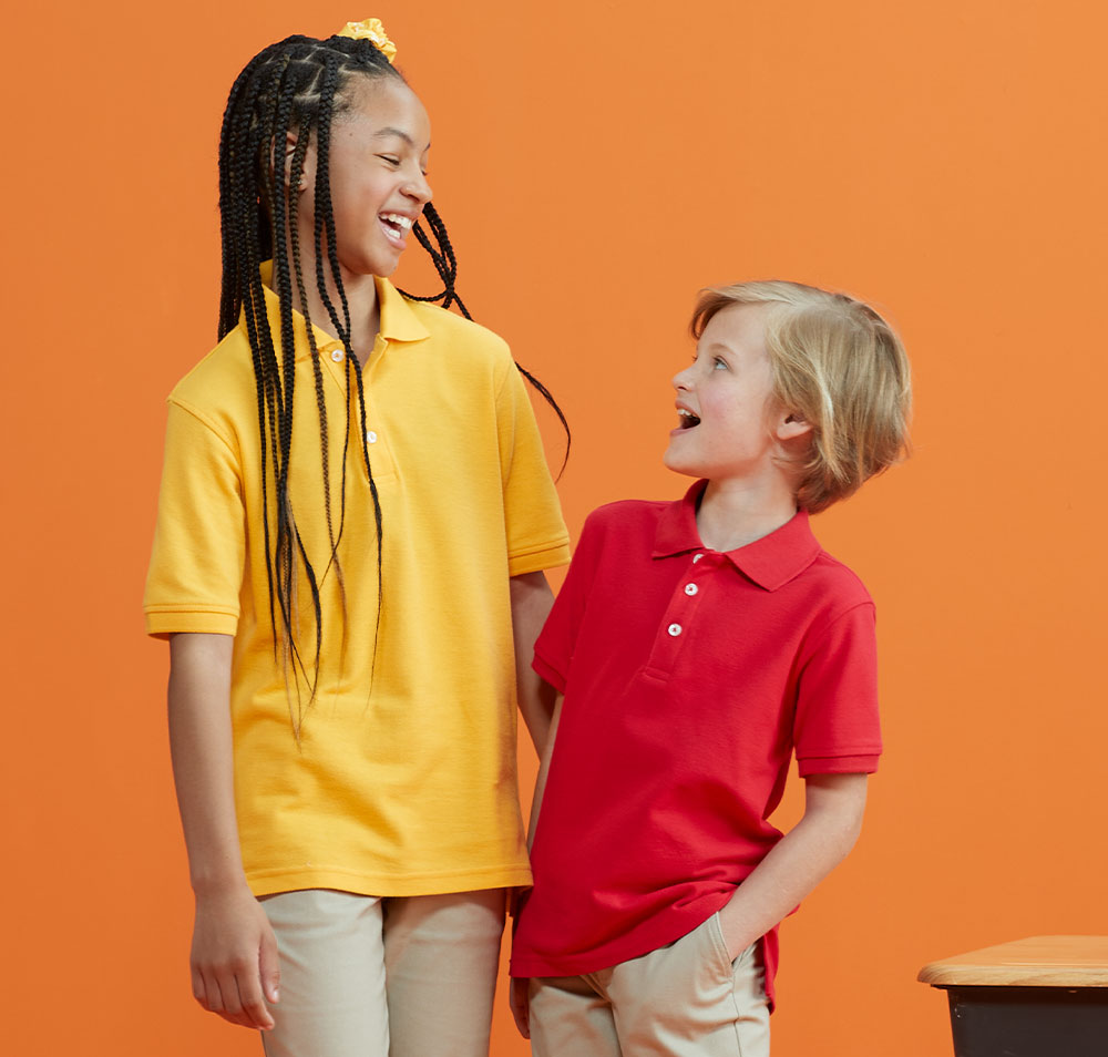 girl and boy wearing khakis and short sleeve pique polos