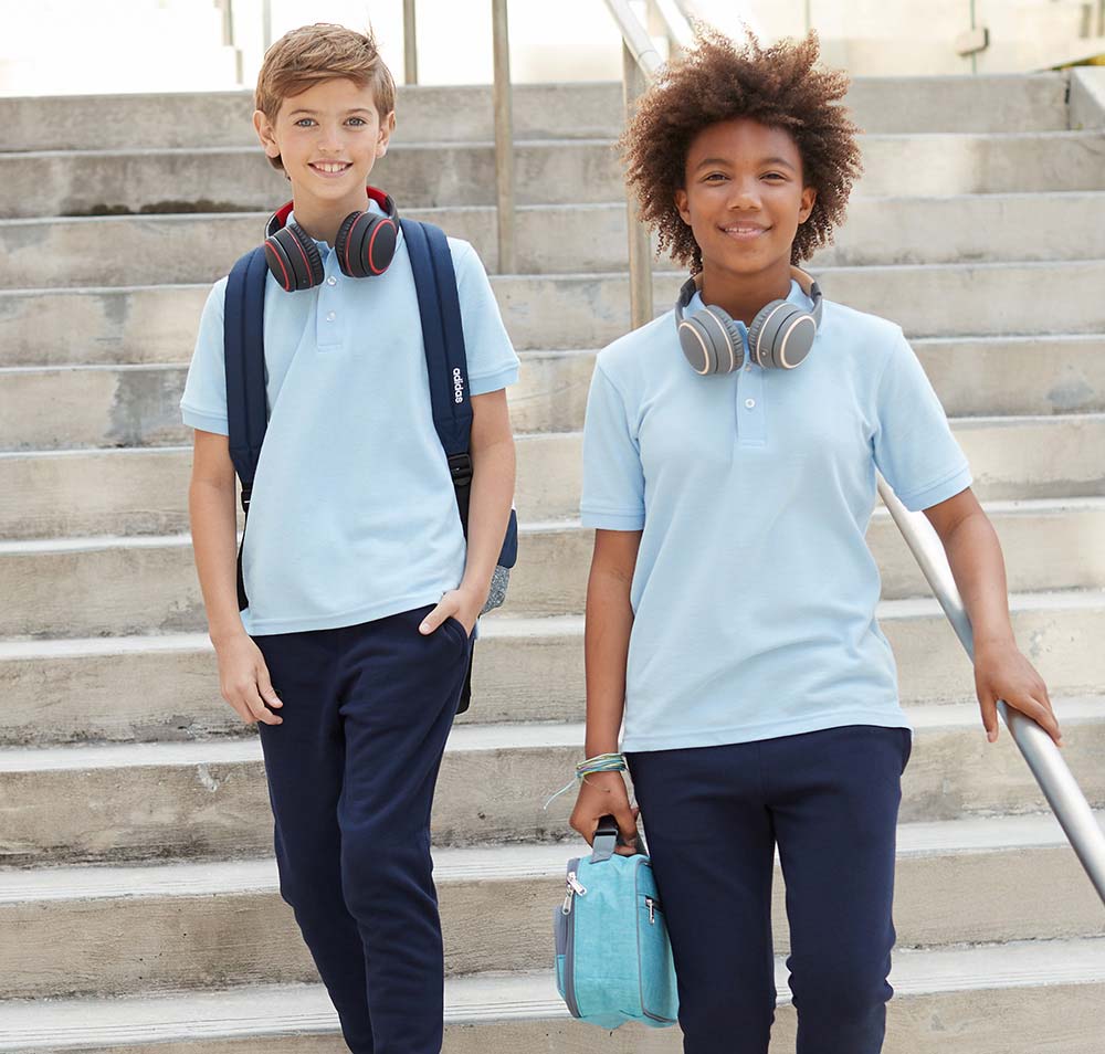 two kids wearing blue polos and navy pants