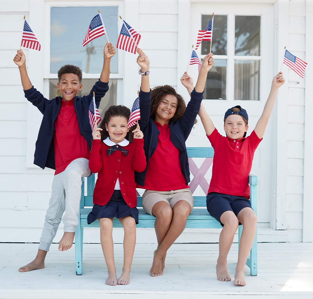 four kids waving usa flags