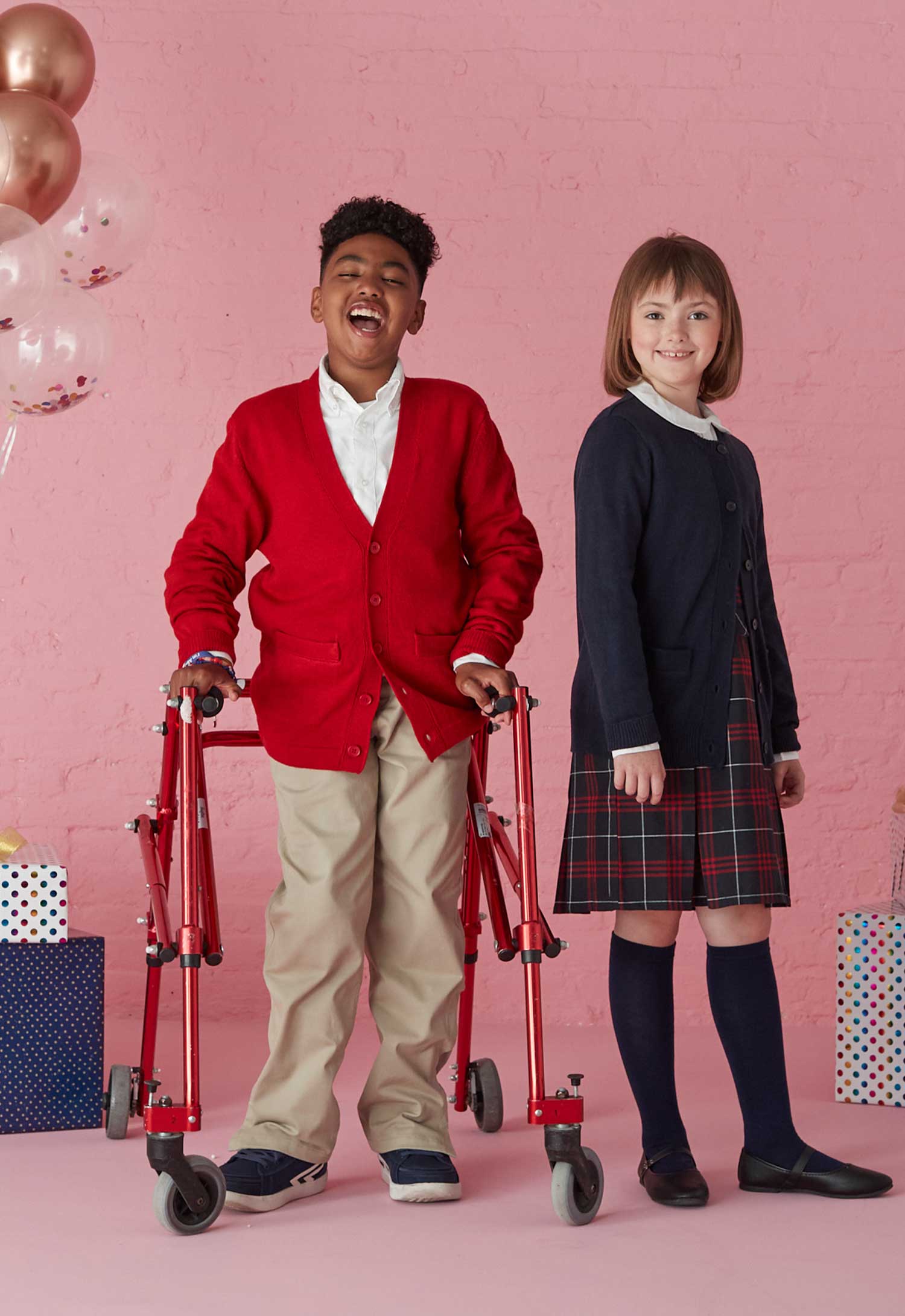 boy wearing a v-neck cardigan and girl wearing a crewneck cardigan