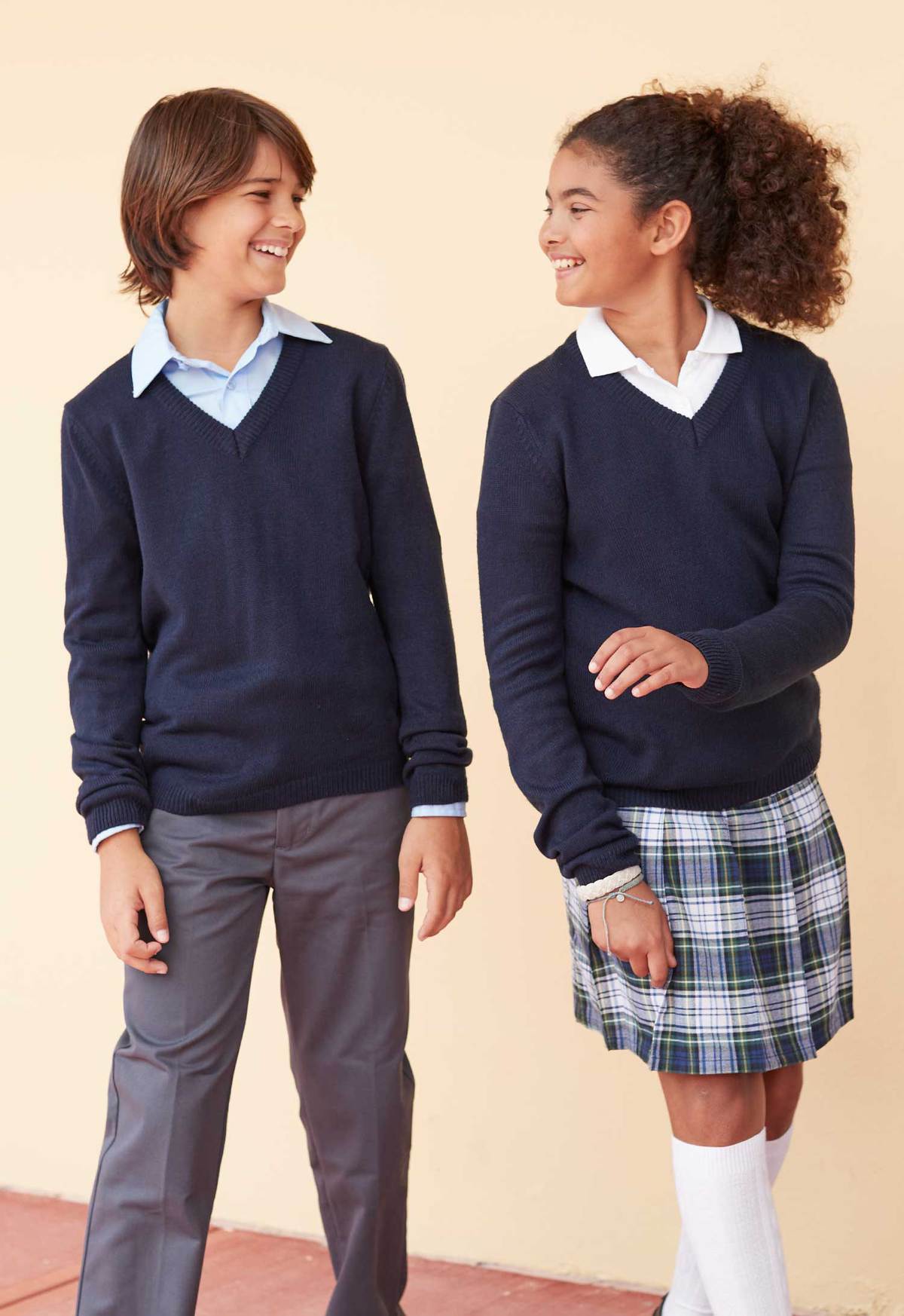 Boy and girl in uniforms sweaters