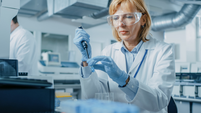 Scientist Extracting a Rack Tube With Urine Samples. Closeup of a Scientist Working With Urine Samples in Lab.