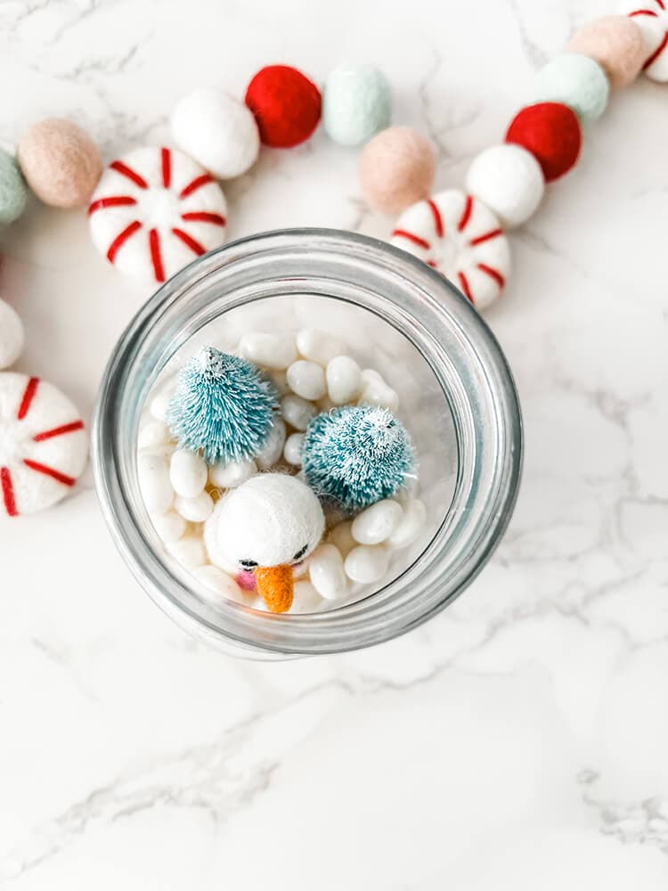 top view of candy decor with white jelly beans in jar