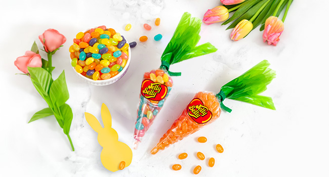 Spring Mix and Tangerine Baby Carrot bags on a table with flowers and a cut-out bunny