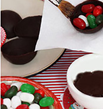 Filling half chocolate ball removed from mold with Jelly belly jelly beans