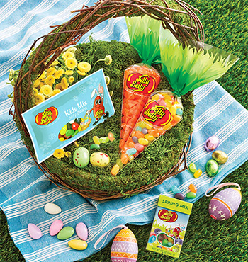 Easter basket with Jelly Belly Tangerine and Spring Mix Baby Carrot bags and Kids Mix 1 oz Bag on a blue picnic blanket