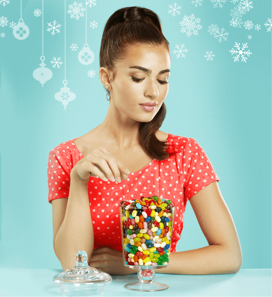 Young woman reaching for Jelly Belly Jelly Beans in a glass jar
