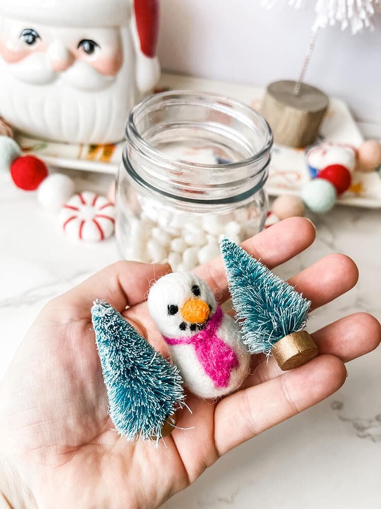 holding candy decor of christmas trees and a snowman